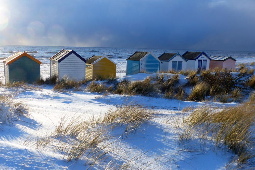 Beach huts in snow in Suffolk