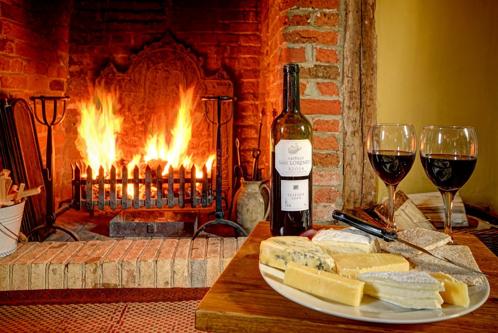 Woodfarm House fireplace with wine and cheese