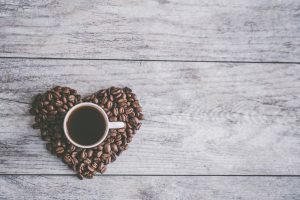 Aerial view of a coffee cup surrounded by beans