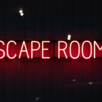 A neon sign spelling out "Escape Rooms"