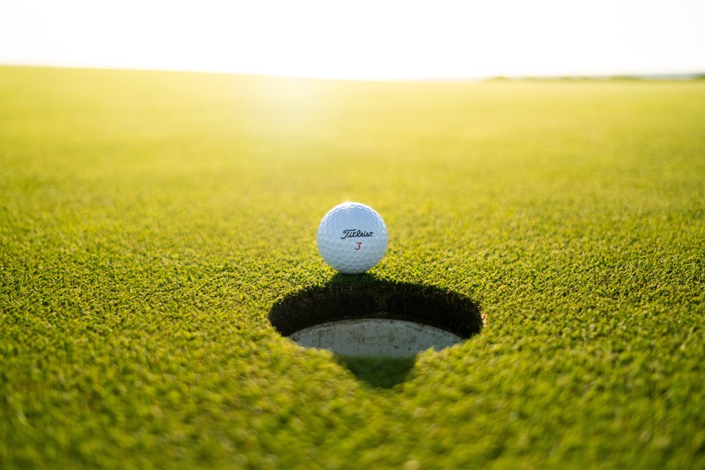 A golf ball close to the hole