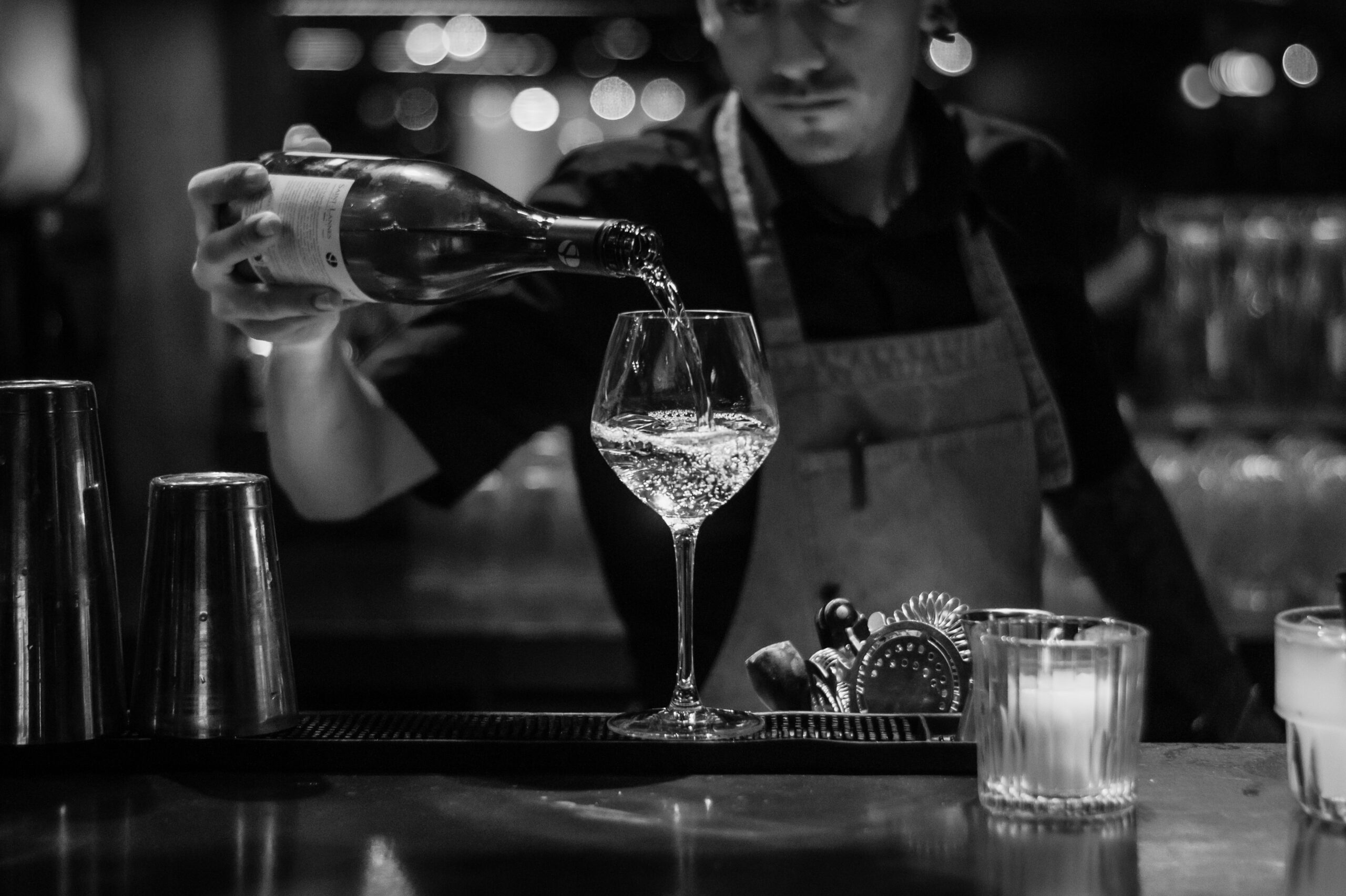 A black and white shot of a wine being poured