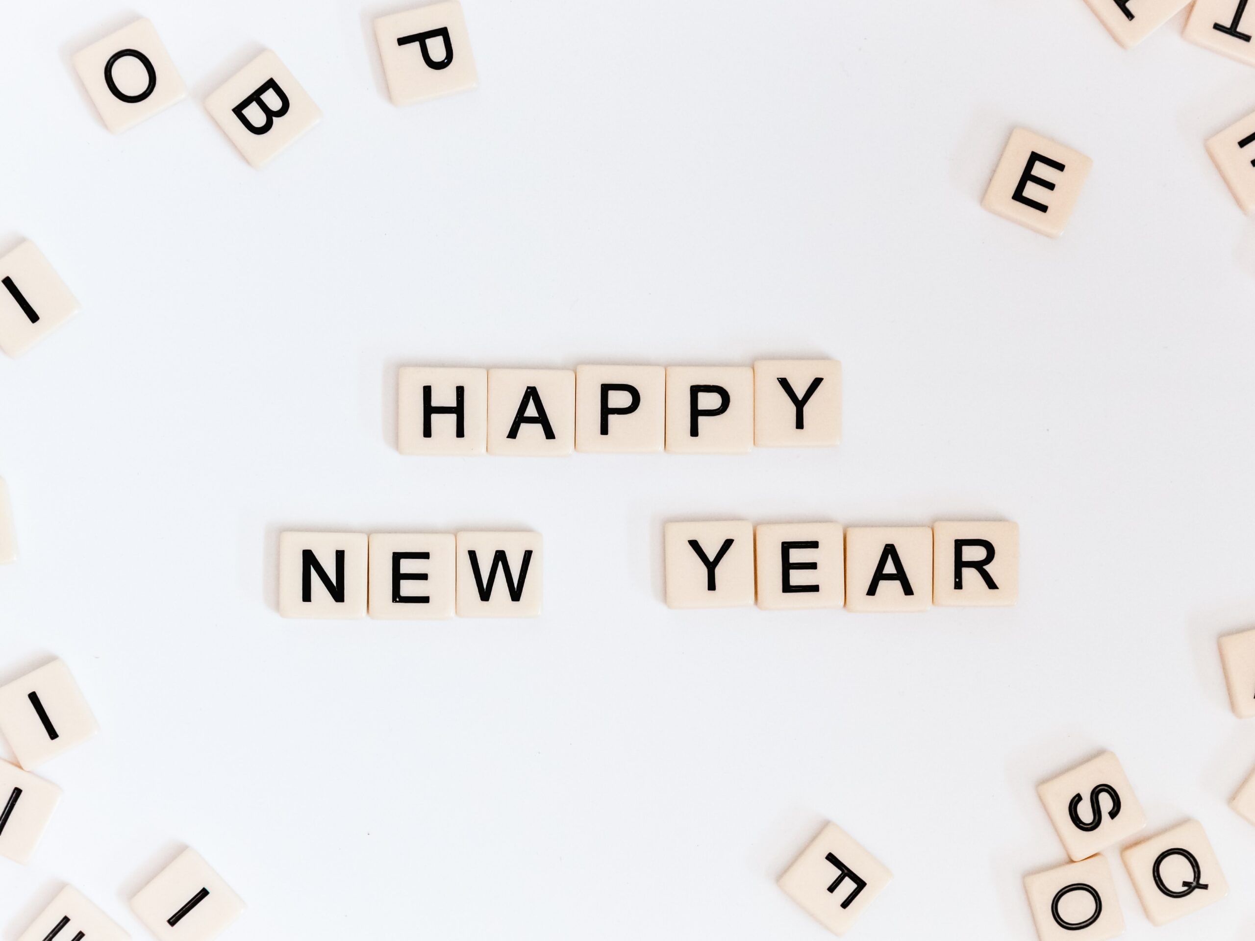 The words happy new year spelled out in scrabble blocks